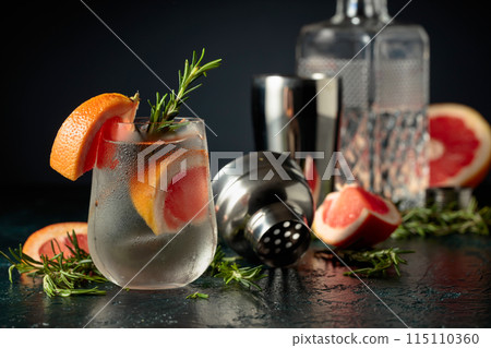Cocktail gin tonic with ice, grapefruit, and rosemary. Cocktail gin tonic with ice, grapefruit, and rosemary. 115110360