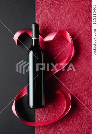 Bottle of red wine with red and pink satin ribbons. Bottle of red wine with red and pink satin ribbons. 115110405