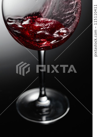 Closeup of red wine pouring. Closeup of red wine pouring. 115110411