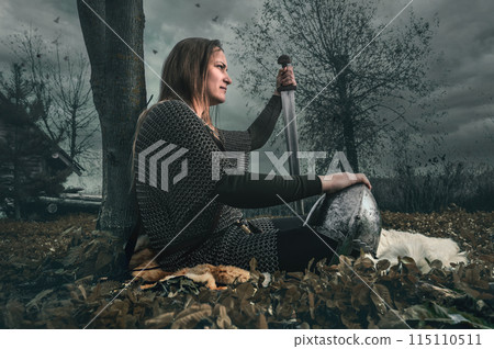 Portrait of woman in image of medieval warrior under dramatic sky. Portrait of woman in image of medieval warrior under dramatic sky. 115110511