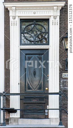 typical century Dutch door holland view in a fortified town with brick houses and front flower gardens. Typical dutch door 115112376