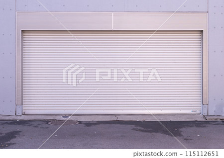 A closeup shot of automatic metal roller door used in factory, storage, garage, and industrial warehouse. The corrugated and foldable metal sheet offer space saving and provide urban and rustic feel 115112651
