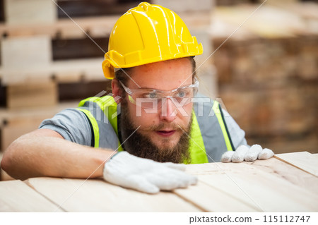 Man engineer carpenter wearing safety uniform and hard hat working checking quality 115112747