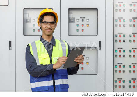 Electrical engineer man using tablet checks switchboard main Distribution Boards control panel Electrical engineer man using tablet checks switchboard main Distribution Boards control panel 115114430