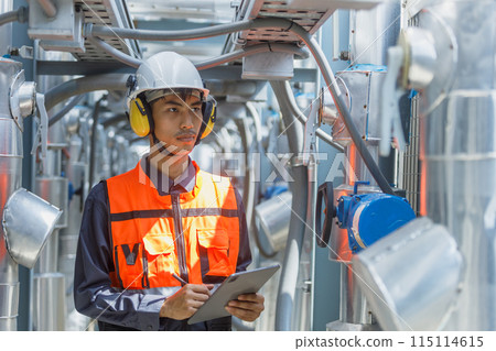 Male operator worker using tablet checking write record quality cooling air piping HVAC system Male operator worker using tablet checking write record quality cooling air piping HVAC system 115114615