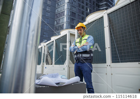 Male operator worker reading blueprint checking drawing plan cooling air piping HVAC system Male operator worker reading blueprint checking drawing plan cooling air piping HVAC system 115114618