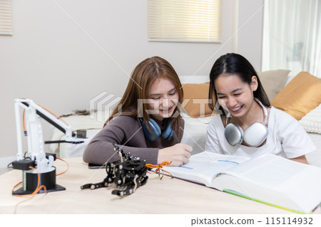 Happy two girl teen smile with braces students education stem hand robot model study 115114932