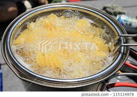 Pasta dishes made outdoors 115114979