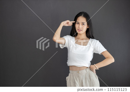 Asian female with braces smiling pointing to head great idea and thinking. happy attractive Asian female with braces smiling pointing to head great idea and thinking. happy attractive 115115123