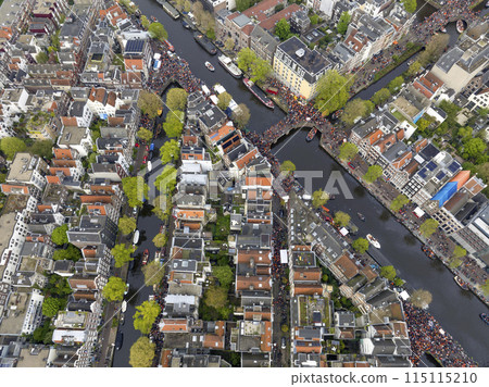 Kings Day 2024 in Amsterdam. Koningsdag, Koeningsdag in Capital of the Netherlands, Aerial Drone Fly Over Orange Suits. 115115210