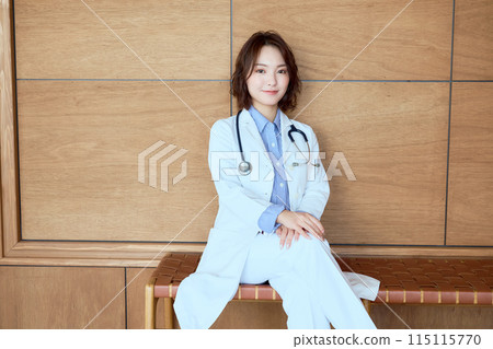 A female doctor in a stylish hospital waiting room A female doctor in a stylish hospital waiting room 115115770