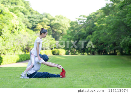 Daughter helping her father with calisthenics Daughter helping her father with calisthenics 115115974