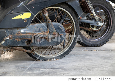 The Remains of an Old, Non-Functional Motorcycle Parked in a Motorcycle Graveyard, Awaiting Destruction The Remains of an Old, Non-Functional Motorcycle Parked in a Motorcycle Graveyard, Awaiting Destruction 115116660