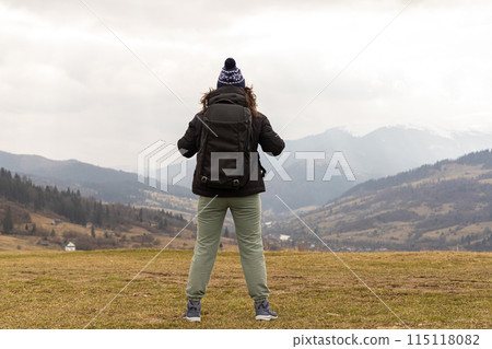 hiking, young woman with a backpack on a high mountain hiking, young woman with a backpack on a high mountain 115118082