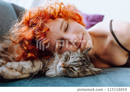 portrait red-haired teenage girl with gray fluffy cat 115118859