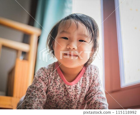 Baby laughing indoors in natural light 115118992