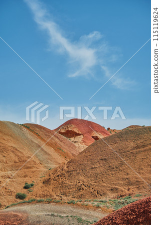 Vertical postcard with view of red mountains under bright blue spring sky, picturesque and serene alien landscape with copy space for concept Vertical postcard with view of red mountains under bright blue spring sky, picturesque and serene alien landscape with copy space for concept 115119624
