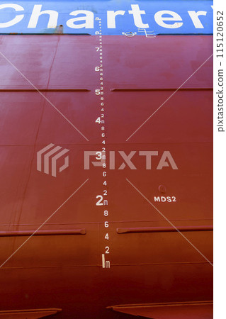 Cargo vessel in dry dock on ship repairing yard. Draught marks. 115120652