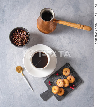 Delicious breakfast with freshly brewed coffee and mini donuts in powdered sugar and lingonberry 115121151