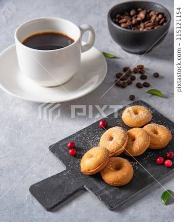 Delicious breakfast with freshly brewed coffee and mini donuts in powdered sugar and lingonberry  115121154