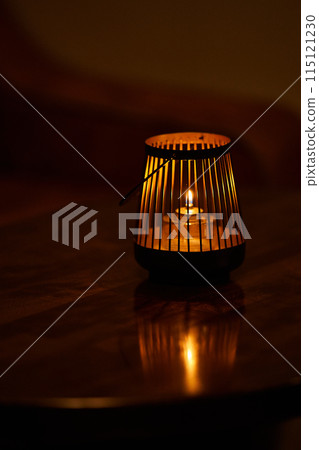 single tea light candle on the table 115121230