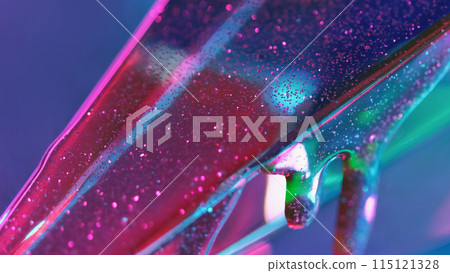 Sparkling liquid. Glowing fluid. Pink shiny gel bubbles flowing down on oil glass texture on blue green defocused abstract background empty space. Sparkling liquid. Glowing fluid. Pink shiny gel bubbles flowing down on oil glass texture on blue green defocused abstract background empty space. 115121328
