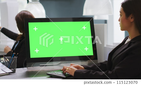 Cad designer using PC with greenscreen at workstation area, examining monitor with blank copyspace design in startup company. Engineer uses isolated chromakey display on computer. Cad designer using PC with greenscreen at workstation area, examining monitor with blank copyspace design in startup company. Engineer uses isolated chromakey display on computer. 115123070