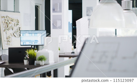Empty engineering office equipped with industrial gear and architectural details, shared workspace area for startup company. 3D construction models, project plans and visual program tools. 115123097
