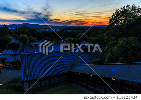 Evening view from Nigatsudo Hall of Todaiji Temple in the ancient city of Nara. The sunset sky and the majestic clouds on Mt. Ikoma remain over the Ikoma mountain range after sunset. Evening view from Nigatsudo Hall of Todaiji Temple in the ancient city of Nara. The sunset sky and the majestic clouds on Mt. Ikoma remain over the Ikoma mountain range after sunset. 115123434