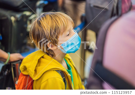 Boy traveler with medical face mask to protection the coronavirus in airport Boy traveler with medical face mask to protection the coronavirus in airport 115123957