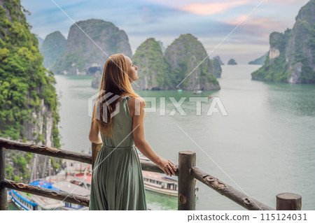 Attractive woman in a dress is traveling in Halong Bay. Vietnam. Travel to Asia, happiness emotion, summer holiday concept. Picturesque sea landscape. Ha Long Bay, Vietnam Attractive woman in a dress is traveling in Halong Bay. Vietnam. Travel to Asia, happiness emotion, summer holiday concept. Picturesque sea landscape. Ha Long Bay, Vietnam 115124031