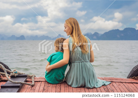 Mom and son travelers is traveling by boat in Halong Bay. Vietnam. Travel to Asia, happiness emotion, summer holiday concept. Traveling with children concept. After COVID 19. Picturesque sea landscape 115124068