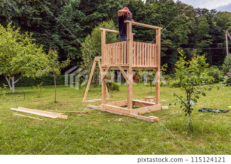 A small playground. Children's wooden house. Children's swing 115124121