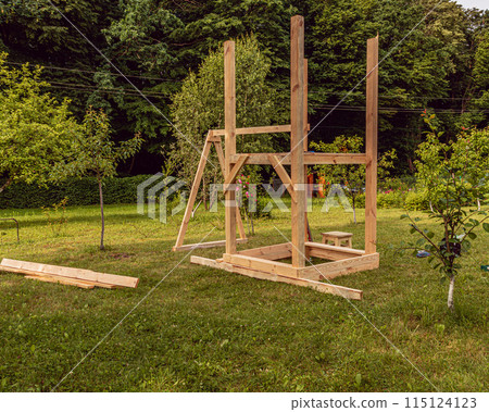 A small playground. Children's wooden house. Children's swing 115124123