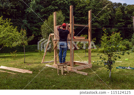 Installation of pearls in a children's hut with a swing in the garden 115124125