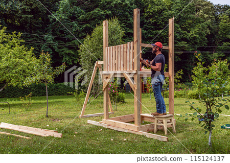 Installation of pearls in a children's hut with a swing in the garden 115124137