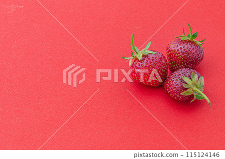 Ripe fresh strawberries on a red background 115124146