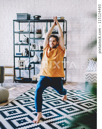 Hipster guy practicing meditation in poses at home 115124493