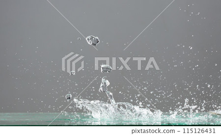 Crown Water splash on object to create shape form fluttering in droplet and wave. Crown water to object make curve drop explosion in ripple motion. Grey background isolated 115126431