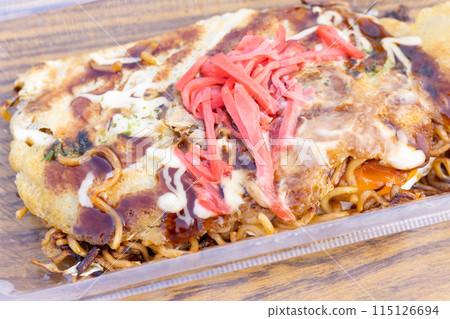 Delicious Hiroshima-style okonomiyaki from a food stall 115126694