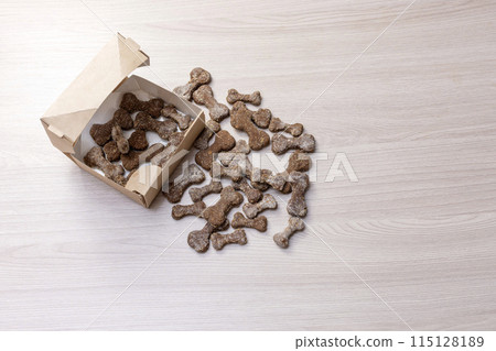 tasty treat for dogs in the form of bones in a cardboard box tasty treat for dogs in the form of bones in a cardboard box 115128189