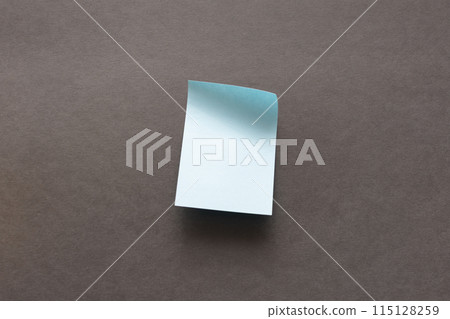 blank blue sticker for notes on a dark surface 115128259