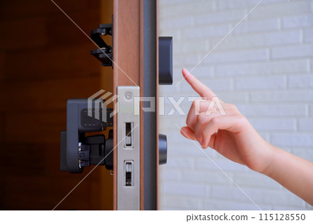 Child's hand unlocking the front door Child's hand unlocking the front door 115128550