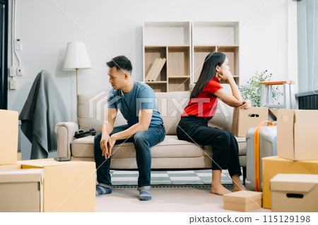 Divorce. Asian couples are desperate and disappointed after marriage. Husband and wife are sad, upset and frustrated after quarrels. family problem, teenage love. on sofa 115129198