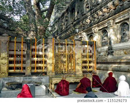 A monk worships facing the Vajra seat to the west of the Great Seated Hall of Bodh Gaya, the sacred place in India where Buddha attained enlightenment. 115129273
