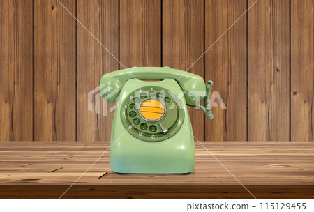 Old fashioned green desk phone on wooden table There is a wooden wall behind it. Old fashioned green desk phone on wooden table There is a wooden wall behind it. 115129455