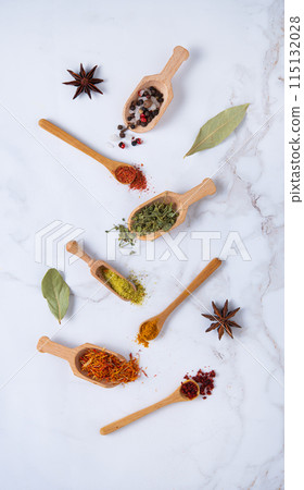 Various spoons of oriental spices on marble background Various spoons of oriental spices on marble background 115132028