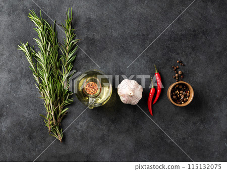 Flat lay of spices and fresh herbs rosemary, garlic, pepper, chili pepper and oil Flat lay of spices and fresh herbs rosemary, garlic, pepper, chili pepper and oil 115132075