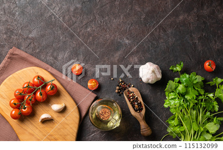 Spices and fresh herbs parsley, garlic, pepper, tomatoes and oil on a dark brown background. Spices and fresh herbs parsley, garlic, pepper, tomatoes and oil on a dark brown background. 115132099