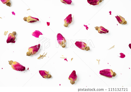 Flat lay dry rose buds on a white background. Concept pattern herbal tea. Top view 115132721